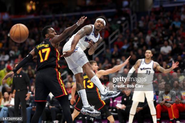 Bradley Beal of the Washington Wizards passes the ball around Onyeka Okongwu of the Atlanta Hawks in the second half at Capital One Arena on March...