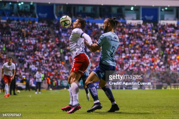 Ronaldo Cisneros of Chivas fights for the ball with Gaston Silva of Puebla during the 11th round match between Puebla and Chivas as part of the...