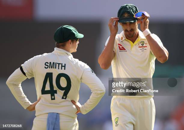 Steve Smith of Australia speaks with Mitchell Starc during day three of the Fourth Test match in the series between India and Australia at Narendra...