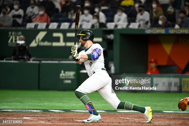 Aaron Whitefield of Team Australia RBI single to make it 0-5 in the third inning during the World Baseball Classic Pool B game between China and...
