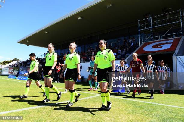 Referees lead teams out during the round 17 A-League Women's match between Adelaide United and Perth Glory at ServiceFM Stadium, on March 11 in...