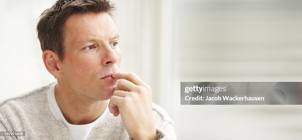 Close-up of a young man thinking and looking away