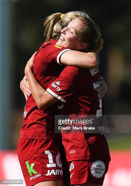 Dylan Holmes and Meisha Westland of Adelaide United celebrate the final whistle and during the round 17 A-League Women's match between Adelaide...