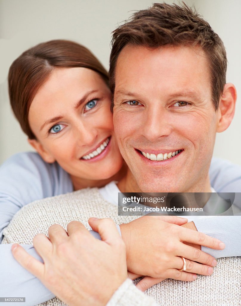 Close-up of a young couple smiling and embracing