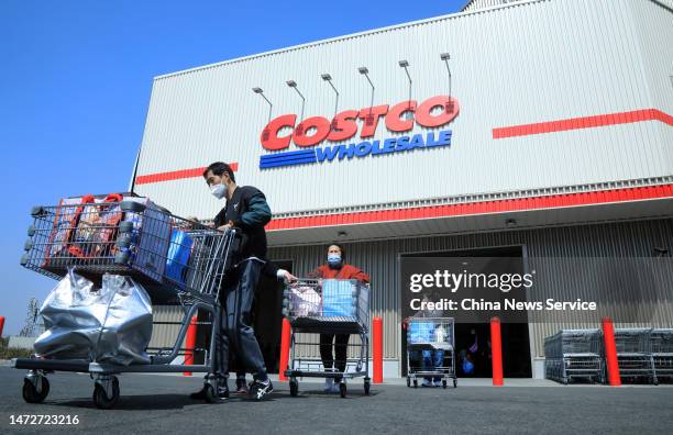 Customers push shopping carts outside a Costco store on the first day of its trial operation on March 10, 2023 in Shanghai, China. U.S. Retail giant...