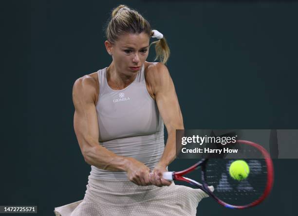 Camila Giorgi of Italy plays a backhand in her match against Jessica Pegula of the united States during the BNP Parisbas at the Indian Wells Tennis...