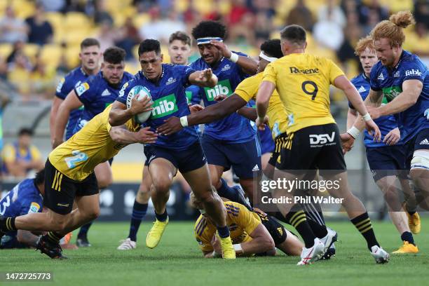 Roger Tuivasa-Sheck of the Blues is tackled during the round three Super Rugby Pacific match between Hurricanes and Blues at Sky Stadium, on March 11...