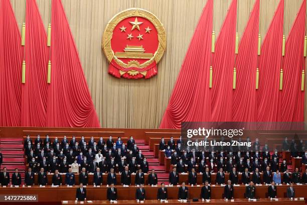 Chinese President Xi Jinping, and members of the government sing the national anthem at the fourth plenary session of the National People's Congress...