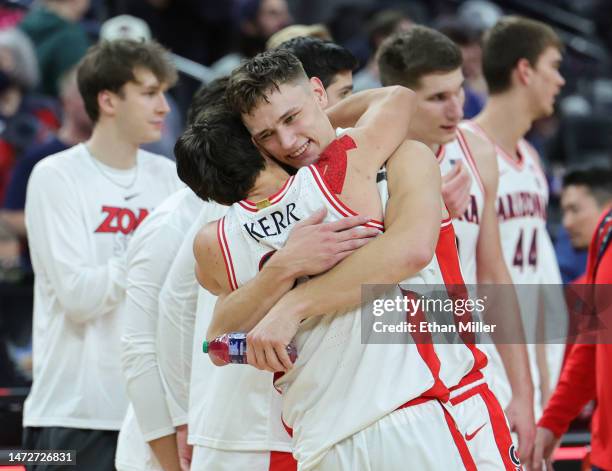 Kerr Kriisa and Pelle Larsson of the Arizona Wildcats celebrate on the court after their 78-59 victory over the Arizona State Sun Devils in a...