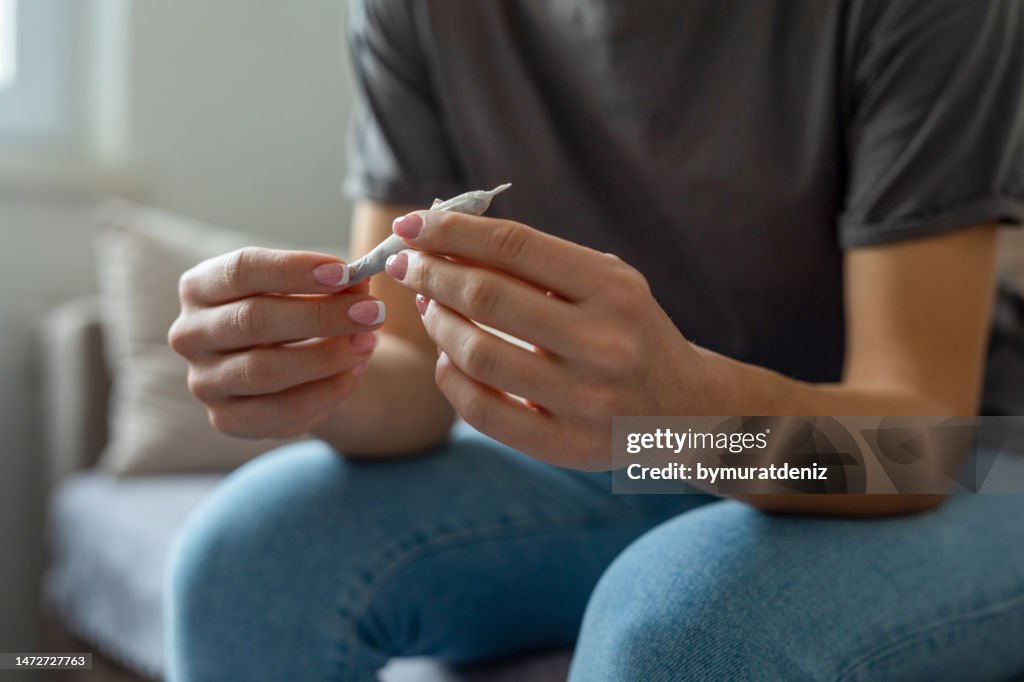 Woman using marijuana at home