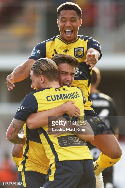 Jason Cummings of the Mariners celebrates with team mates after scoring a goal during the round 20 A-League Men's match between Central Coast...