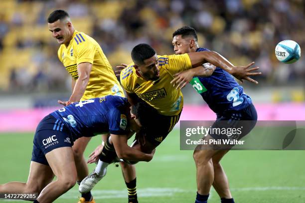 Salesi Rayasi of the Hurricanes offloads the ball during the round three Super Rugby Pacific match between Hurricanes and Blues at Sky Stadium, on...
