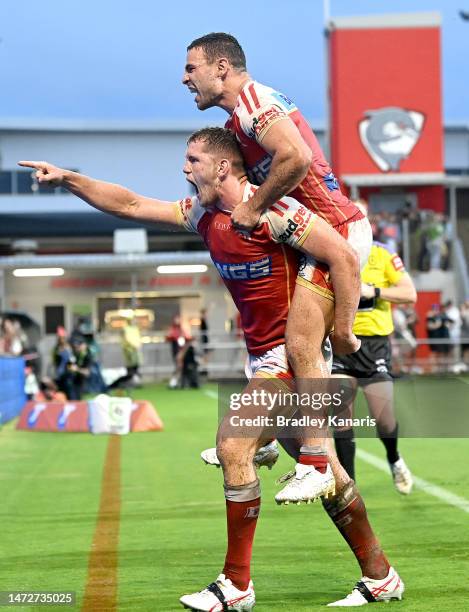 Tom Gilbert of the Dolphins celebrates scoring a try during the round two NRL match between the Dolphins and the Canberra Raiders at Kayo Stadium on...