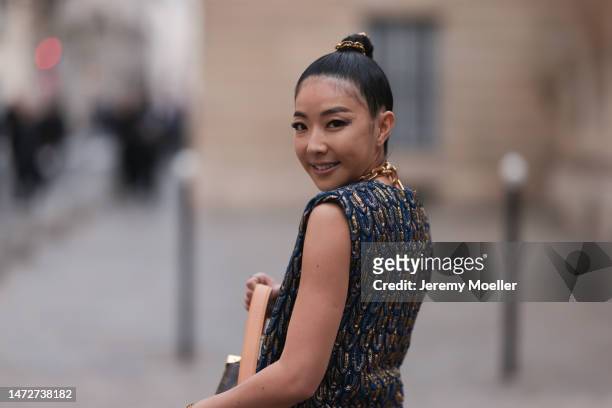 Yuwei Zhangzou is seen wearing navy and gold top and matching skirt outside the Louis Vuitton show during Paris Fashion Week - Womenswear Fall Winter...