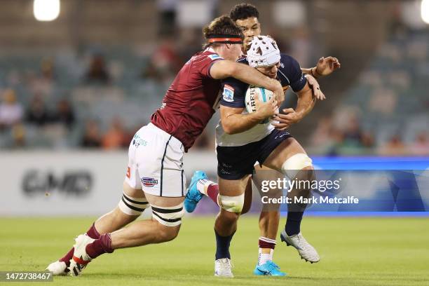 Rory Scott of the Brumbies is tackled during the round three Super Rugby Pacific match between ACT Brumbies and Queensland Reds at GIO Stadium, on...