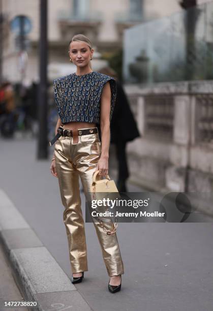 Victoria Magrath is seen wearing sleeveless blue and gold cropped top, golden varnished pants with black belt, yellow Louis Vuitton bag outside the...