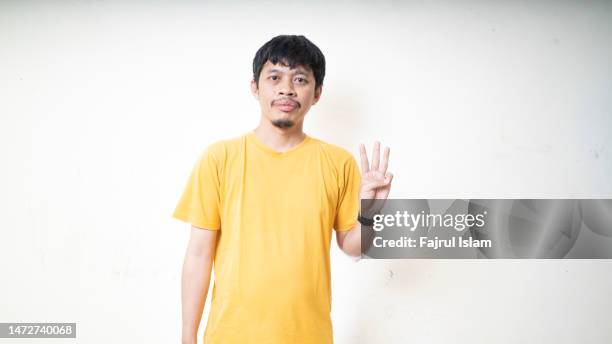 asian men showing number with his finger - three fingers stock pictures, royalty-free photos & images