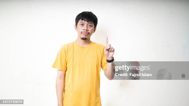 portrait of asian young man showing one finger - blank face stock pictures, royalty-free photos & images