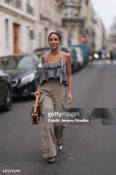 Tamara Kalinic, is seen wearing grey top, beige high waisted cargo pants with side pockets, logo printed Louis Vuitton bag, pointed heels outside the...