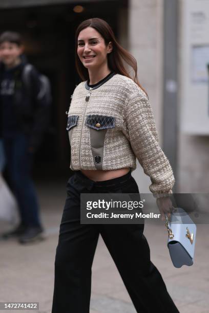 Gala Gonzalez is seen wearing blue Louis Vuitton leather handbag, beige Louis Vuitton zipper jacket, black flared pants outside the Louis Vuitton...
