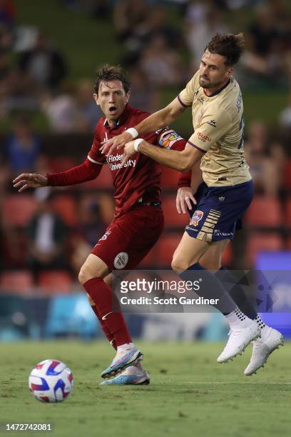 Craig Goodwin of Adelaide United competes for the ball with Carl Jenkinson of the Jets during the round 20 A-League Men's match between Newcastle...