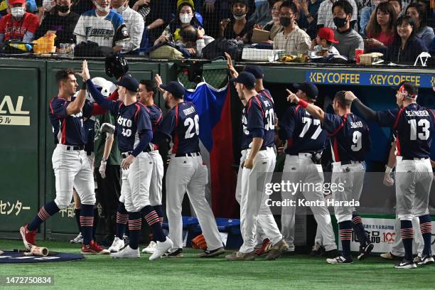 Marek Chlup of the Czech Republic celebrates with teammates after scoring a run by the throwing error of Takumu Nakano of Japan to make it 1-0 in the...