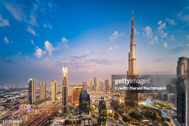 aerial view of city buildings during sunset, dubai, united arab emirates - burj khalifa stock-fotos und bilder