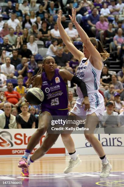 Tiffany Mitchell of the Boomers drives past Sara Blicavs of the Flyers during game two of the WNBL Semi Final series between Melbourne Boomers and...