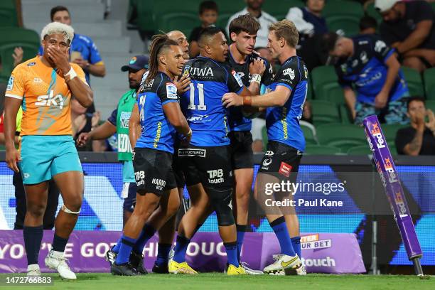 Team mates get around George Poolman of the Force after crossing for a try during the round three Super Rugby Pacific match between Western Force and...