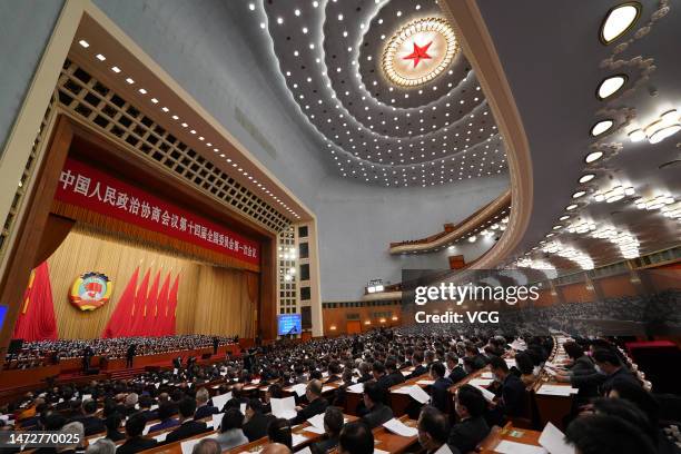 Members of the 14th National Committee of the Chinese People's Political Consultative Conference attend the closing meeting of the first session of...