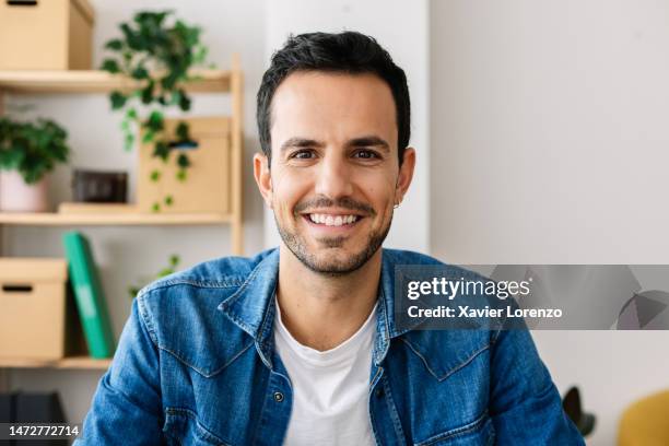 point of view or pov from camera of smiling handsome young creative man making video call from bright home office. - videogesprek stockfoto's en -beelden