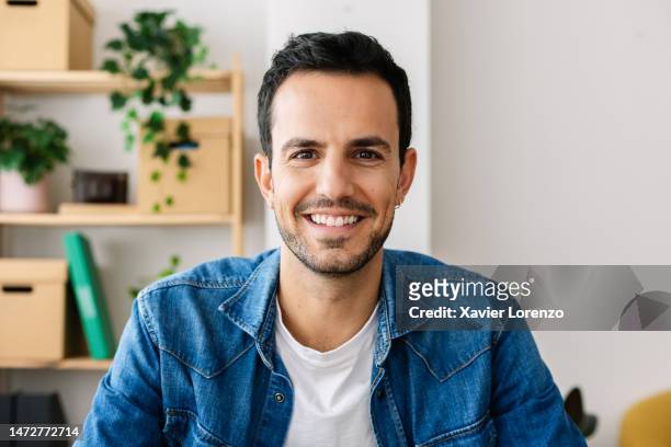 point of view or pov from camera of smiling handsome young creative man making video call from bright home office. - skype call stock pictures, royalty-free photos & images