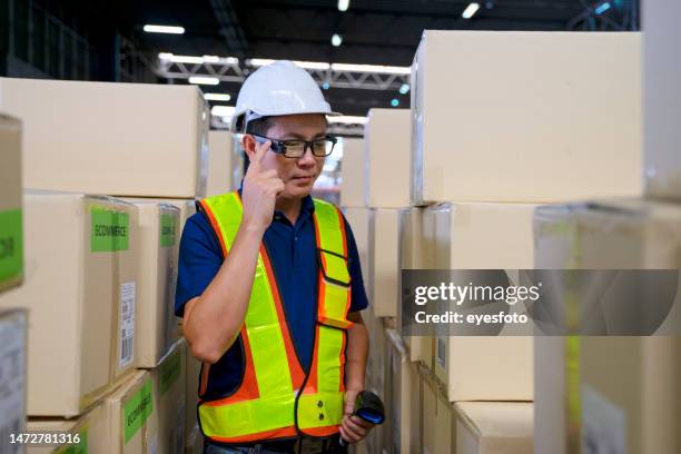 blue collar work at logistic warehouse. - smart glasses stock pictures, royalty-free photos & images