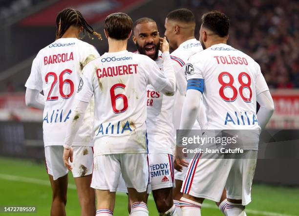 Alexandre Lacazette of Lyon celebrates his second goal with teammates during the Ligue 1 match between Lille OSC and Olympique Lyonnais at Stade...