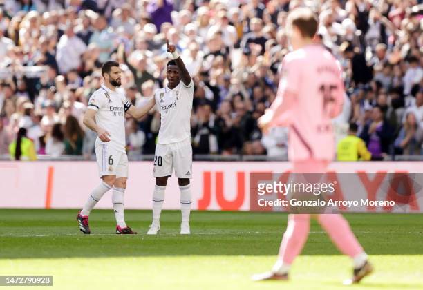 Vinicius Junior of Real Madrid celebrates with teammate Nacho Fernandez after scoring the team's first goal during the LaLiga Santander match between...