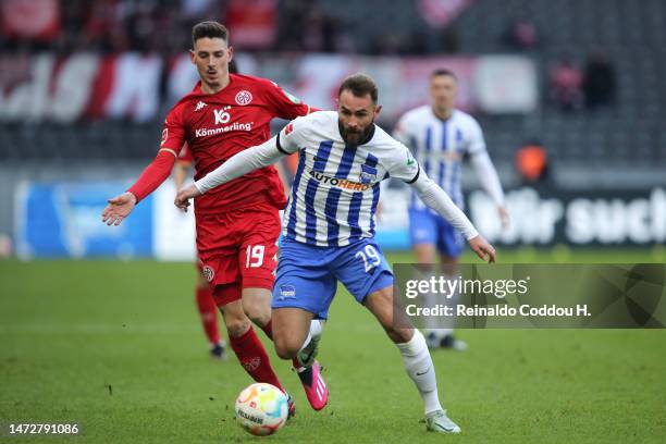 Lucas Tousart of Hertha Berlin runs with the ball whilst under pressure from Anthony Caci of 1.FSV Mainz 05 during the Bundesliga match between...