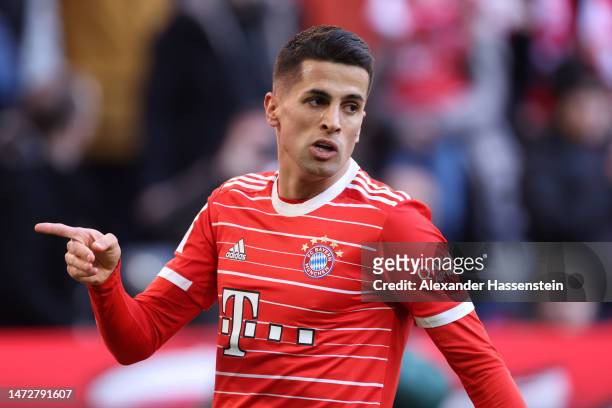 Joao Cancelo of FC Bayern Munich celebrates after scoring the team's first goal during the Bundesliga match between FC Bayern Muenchen and FC...
