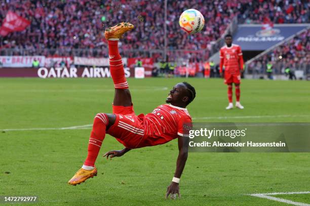 Sadio Mane of FC Bayern Munich performs a bicycle kick to assist their team's second goal, scored by teammate Benjamin Pavard during the Bundesliga...