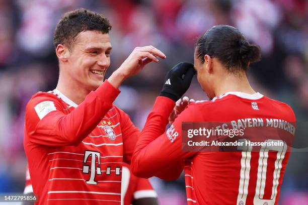 Leroy Sane of FC Bayern Munich celebrates with teammate Benjamin Pavard after scoring the team's fourth goal during the Bundesliga match between FC...