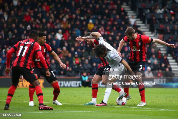 Liverpool's Mohamed Salah looks to hold off Bournemouth defenders Jack Stephens and Marcos Senesi during the Premier League match between AFC...