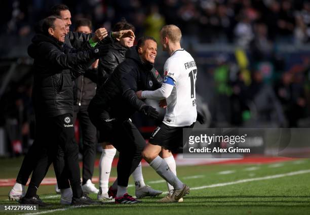 Sebastian Rode of Eintracht Frankfurt celebrates with teammate Timmy Chandler after scoring the team's first goal during the Bundesliga match between...