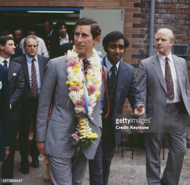 British Royal Charles, Prince of Wales, wearing a traditional garland with a tilaka on his forehead, as he attends the opening of Gita Hall, an...