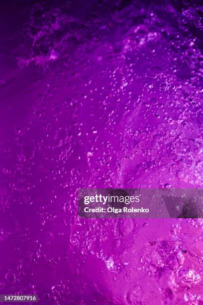 abstract background purple water surface with bubbles - bath bubble texture stock pictures, royalty-free photos & images