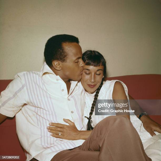 American singer, actor and civil rights activist Harry Belafonte with his arm around his wife, dancer Julie Robinson, who has her hand on Belafonte's...