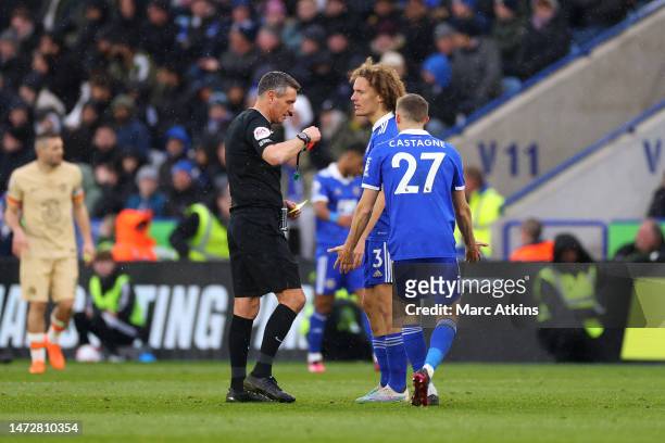 Referee Andre Marriner shows a red card to Wout Faes of Leicester City during the Premier League match between Leicester City and Chelsea FC at The...