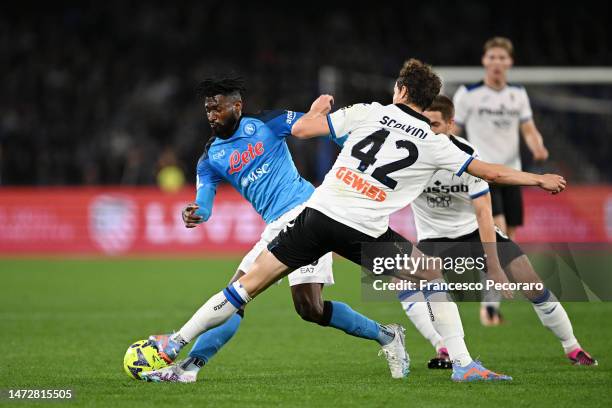 Andre-Frank Zambo Anguissa of SSC Napoli is challenged by Giorgio Scalvini of Atalanta BC during the Serie A match between SSC Napoli and Atalanta BC...