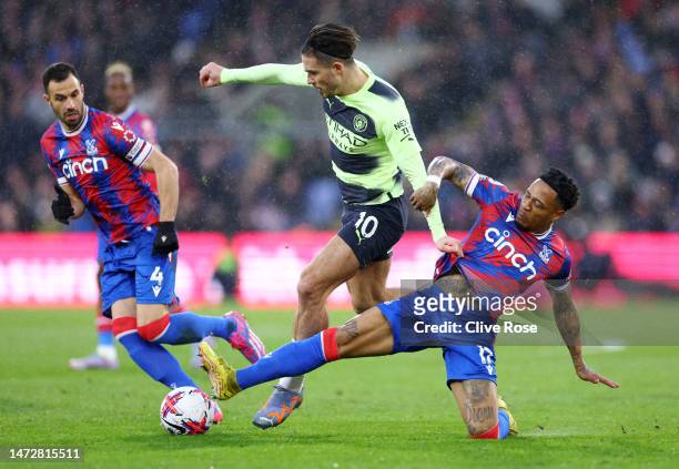 Jack Grealish of Manchester City is challenged by Nathaniel Clyne of Crystal Palace during the Premier League match between Crystal Palace and...