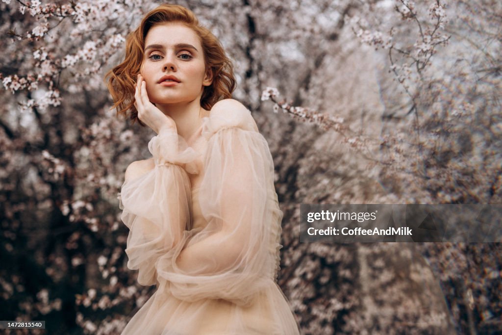 Beautiful girl on the background of spring bush