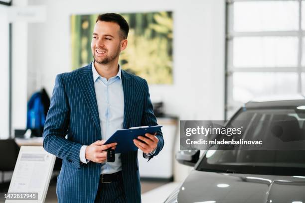 young businessman at car showroom. - geneva international motor show stock pictures, royalty-free photos & images