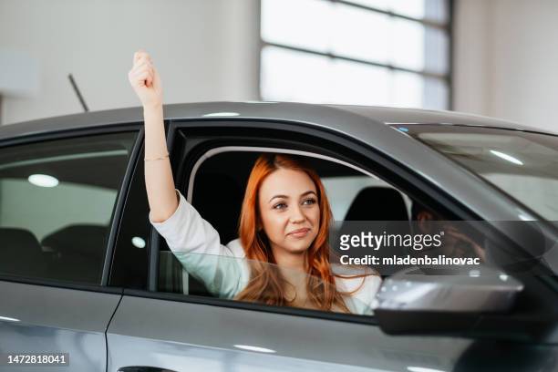young couple at car showroom - geneva international motor show stock pictures, royalty-free photos & images